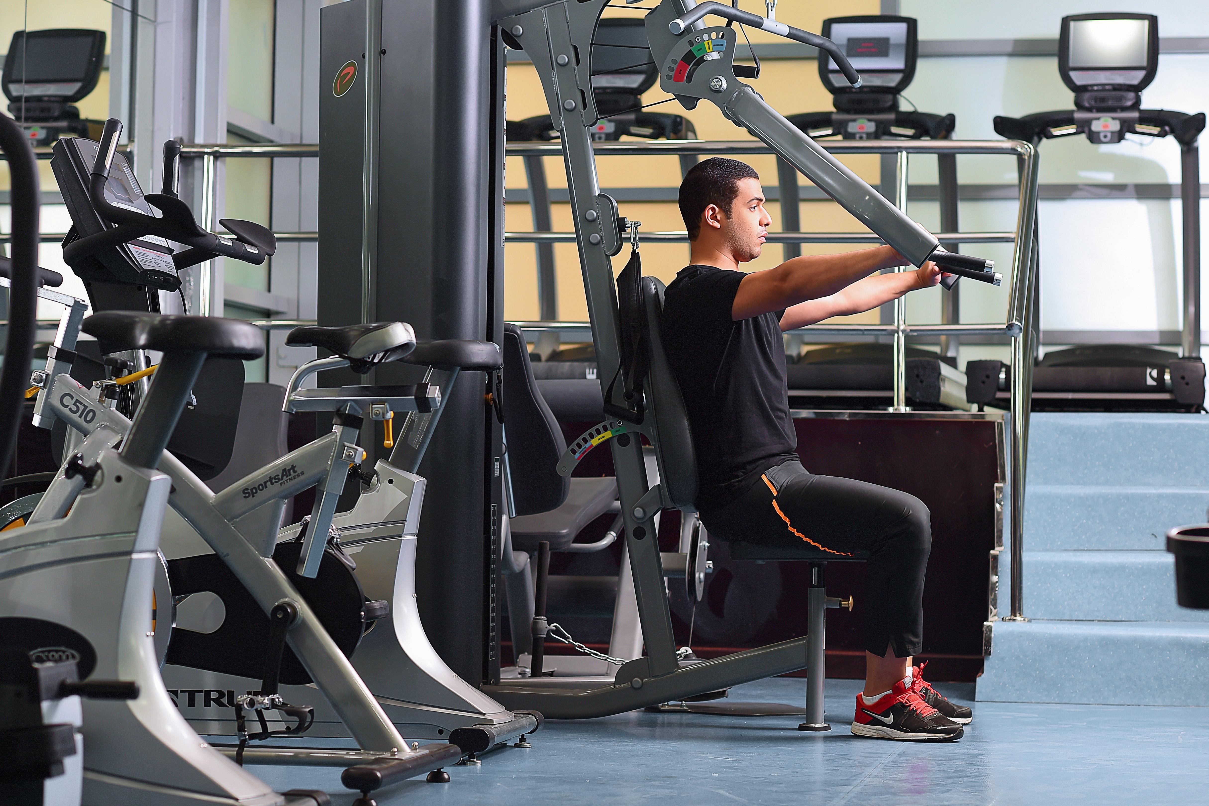 Saraya Corniche Hotel Doha Exterior photo A man using a shoulder press machine